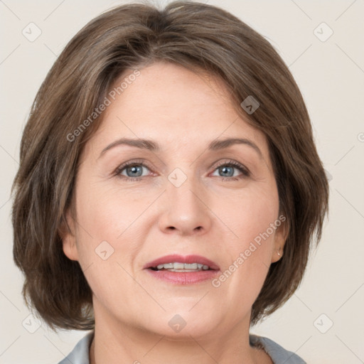 Joyful white adult female with medium  brown hair and grey eyes