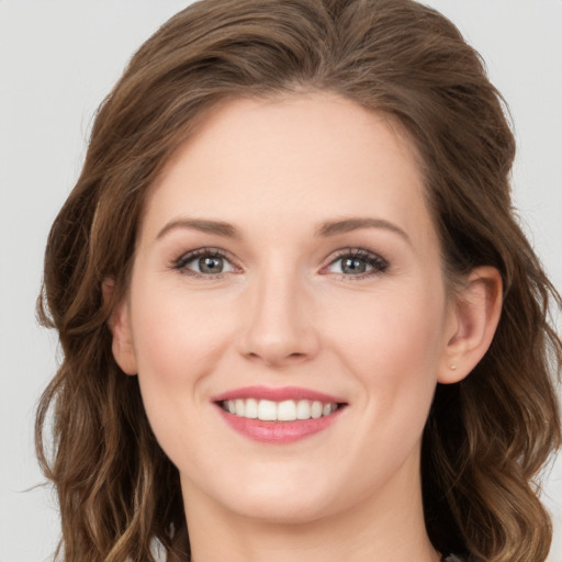 Joyful white young-adult female with long  brown hair and green eyes