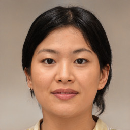 Joyful asian young-adult female with medium  brown hair and brown eyes