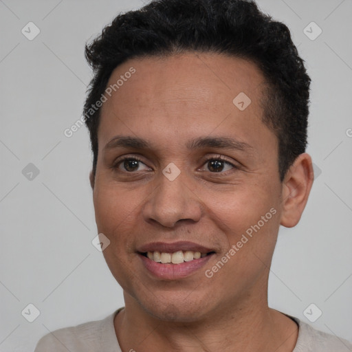 Joyful latino young-adult male with short  black hair and brown eyes