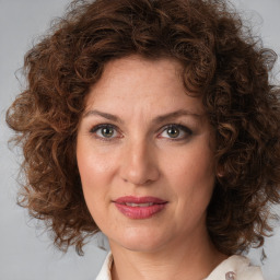 Joyful white adult female with medium  brown hair and brown eyes