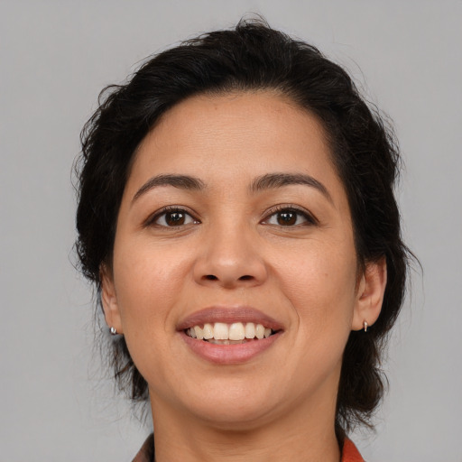 Joyful latino young-adult female with medium  brown hair and brown eyes