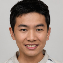 Joyful asian young-adult male with short  black hair and brown eyes