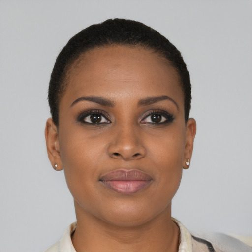 Joyful black young-adult female with short  brown hair and brown eyes
