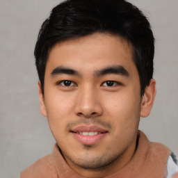 Joyful asian young-adult male with short  black hair and brown eyes