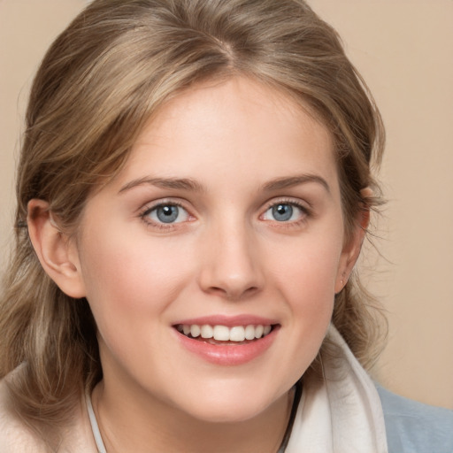 Joyful white young-adult female with medium  brown hair and blue eyes