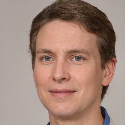 Joyful white adult male with short  brown hair and grey eyes