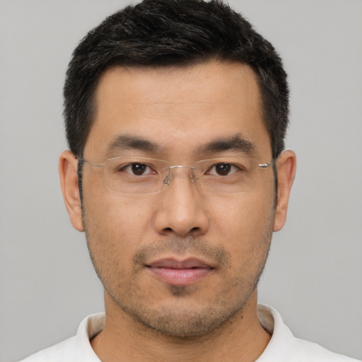 Neutral asian adult male with short  black hair and brown eyes