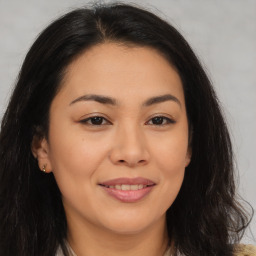 Joyful asian young-adult female with long  brown hair and brown eyes