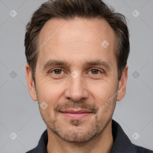 Joyful white adult male with short  brown hair and brown eyes