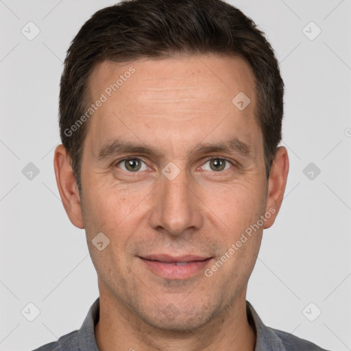 Joyful white adult male with short  brown hair and brown eyes