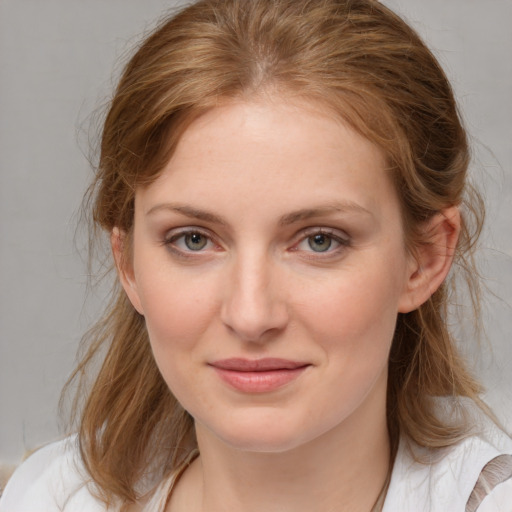 Joyful white young-adult female with medium  brown hair and blue eyes