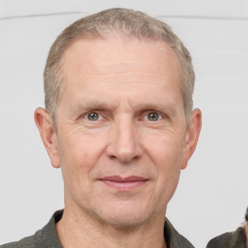 Joyful white middle-aged male with short  brown hair and grey eyes