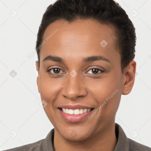 Joyful latino young-adult female with short  brown hair and brown eyes