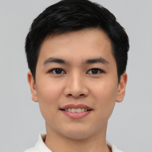 Joyful asian young-adult male with short  black hair and brown eyes