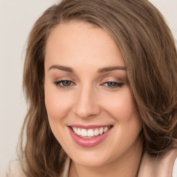 Joyful white young-adult female with long  brown hair and green eyes