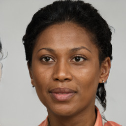 Joyful black adult female with short  brown hair and brown eyes