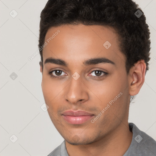 Joyful latino young-adult male with short  brown hair and brown eyes