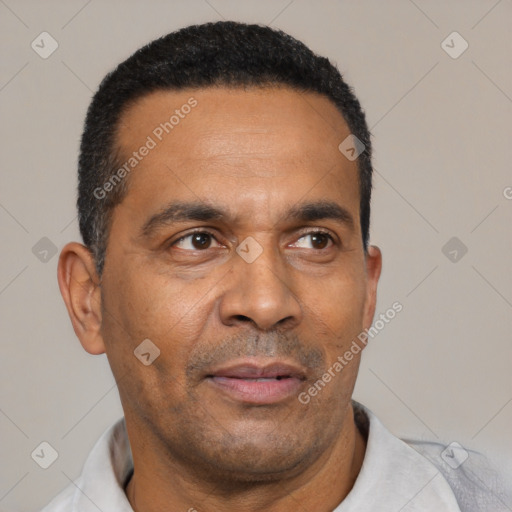 Neutral latino adult male with short  black hair and brown eyes