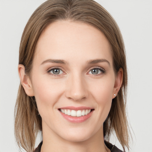 Joyful white young-adult female with medium  brown hair and grey eyes