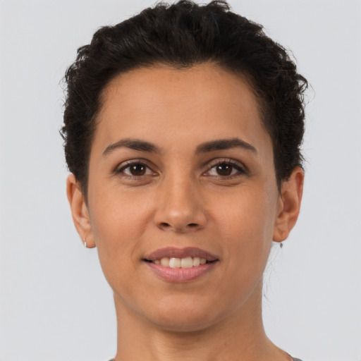 Joyful latino young-adult female with short  brown hair and brown eyes