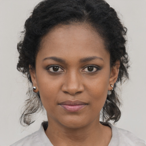 Joyful black young-adult female with short  brown hair and brown eyes