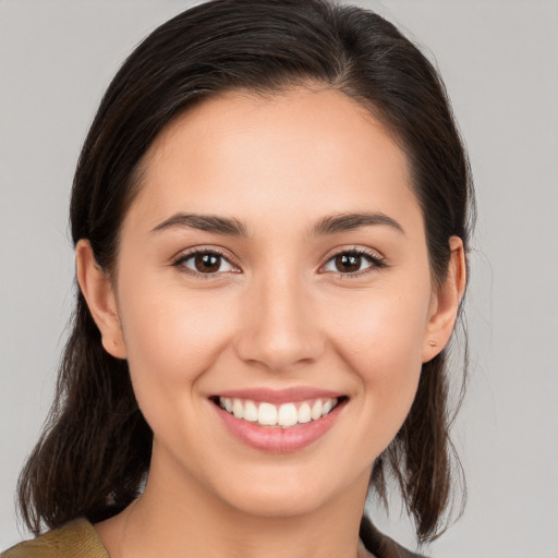 Joyful white young-adult female with medium  brown hair and brown eyes