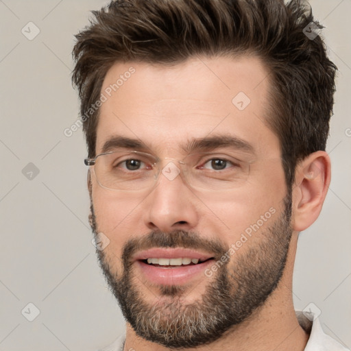 Joyful white adult male with short  brown hair and brown eyes