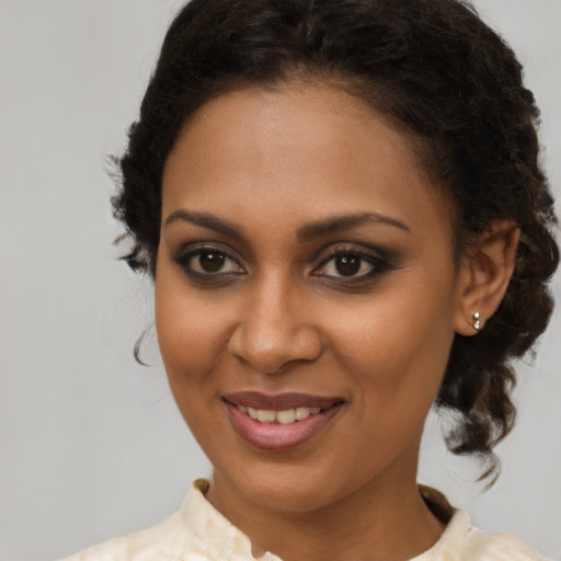 Joyful black young-adult female with medium  brown hair and brown eyes