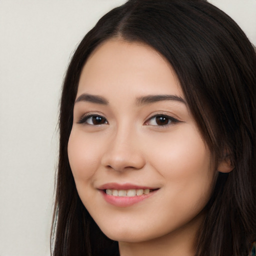 Joyful white young-adult female with long  black hair and brown eyes