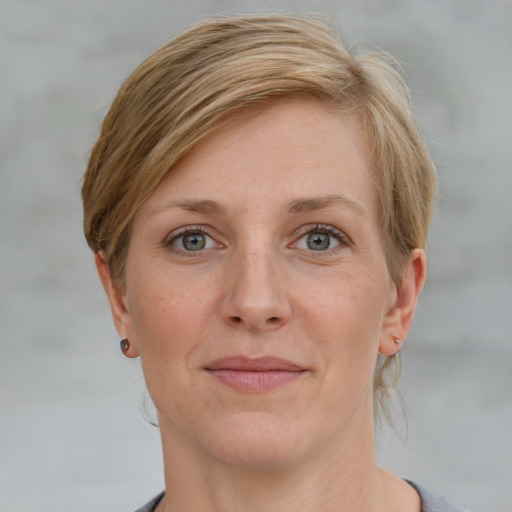 Joyful white adult female with short  brown hair and grey eyes