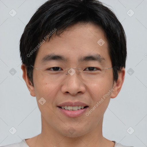 Joyful asian young-adult male with short  brown hair and brown eyes