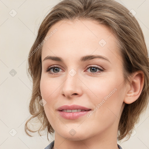 Joyful white young-adult female with medium  brown hair and blue eyes