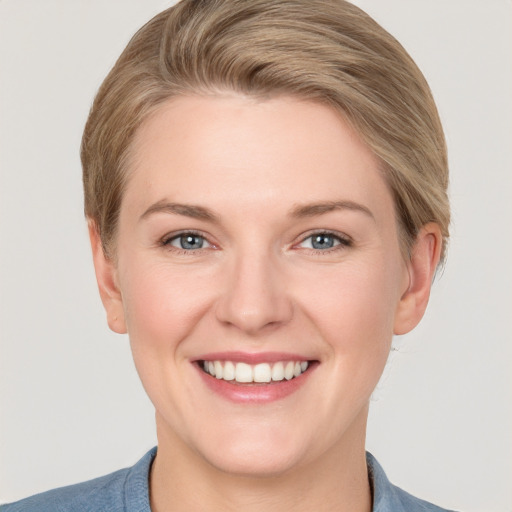 Joyful white young-adult female with short  brown hair and grey eyes