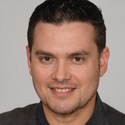 Joyful white adult male with short  brown hair and brown eyes