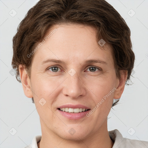 Joyful white young-adult female with short  brown hair and grey eyes