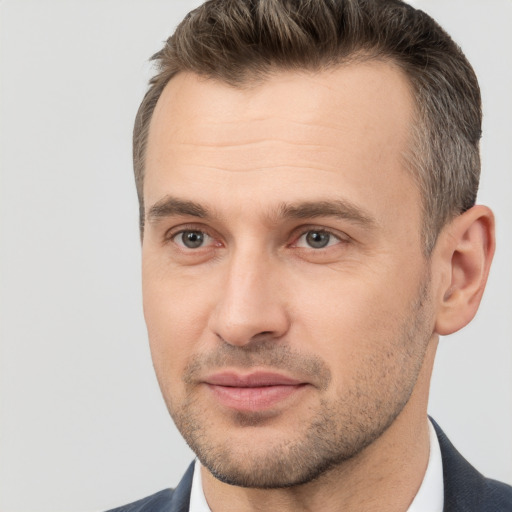 Joyful white adult male with short  brown hair and brown eyes