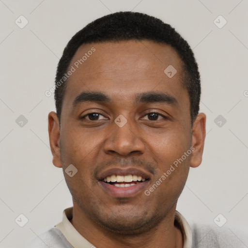 Joyful black young-adult male with short  black hair and brown eyes