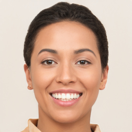 Joyful latino young-adult female with short  brown hair and brown eyes