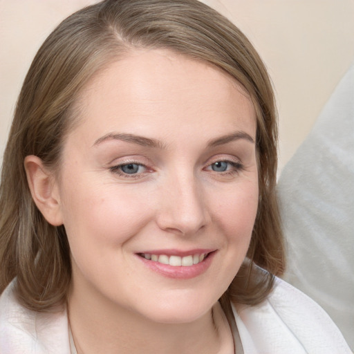 Joyful white young-adult female with medium  brown hair and blue eyes