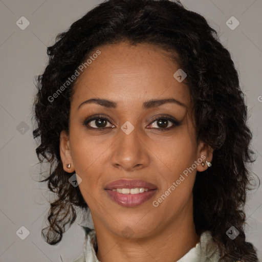 Joyful black adult female with long  brown hair and brown eyes