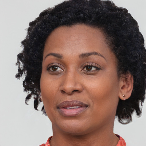 Joyful black adult female with medium  black hair and brown eyes