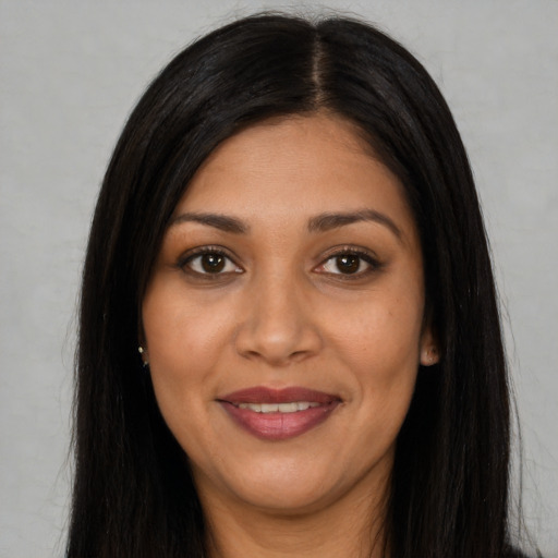 Joyful latino young-adult female with long  black hair and brown eyes