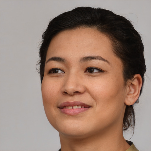 Joyful asian young-adult female with medium  brown hair and brown eyes
