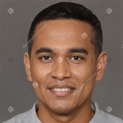 Joyful latino young-adult male with short  black hair and brown eyes