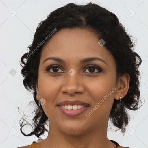 Joyful black young-adult female with long  brown hair and brown eyes