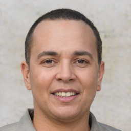 Joyful white adult male with short  brown hair and brown eyes