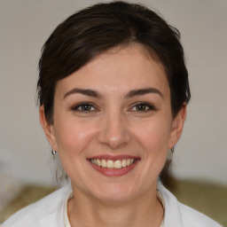 Joyful white young-adult female with medium  brown hair and brown eyes