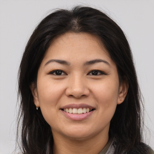 Joyful asian young-adult female with long  brown hair and brown eyes