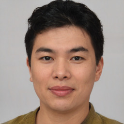 Joyful asian young-adult male with short  brown hair and brown eyes